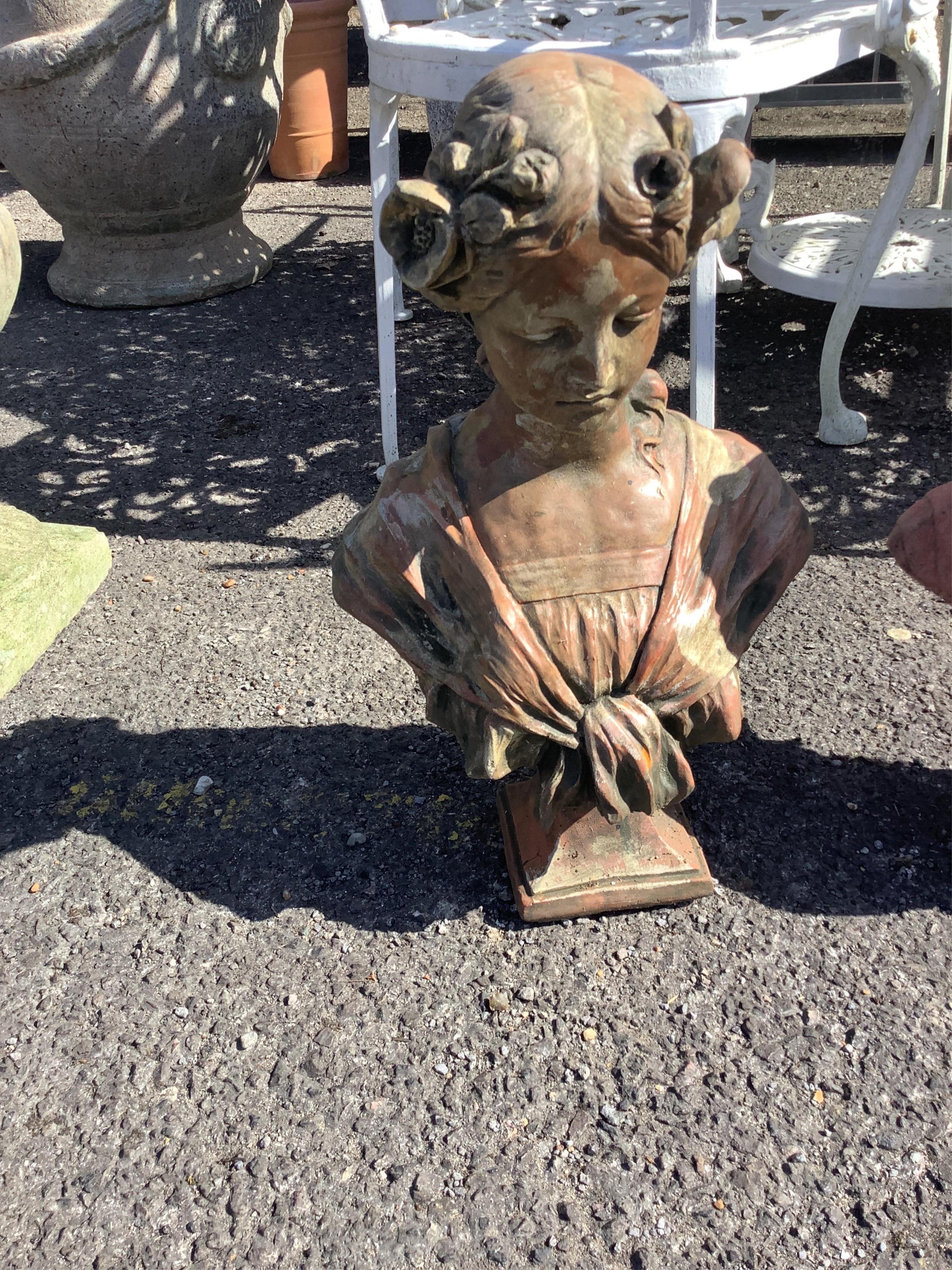 Four cast stone and terracotta garden busts, largest height 46cm